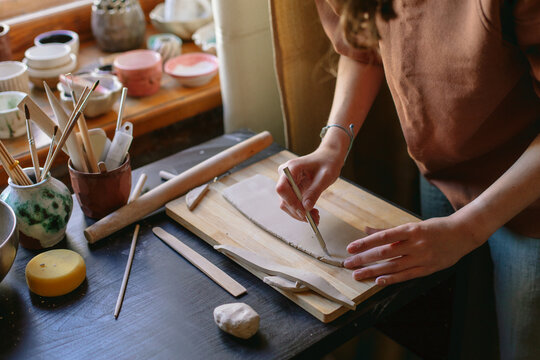 hands of a pottery master with a product