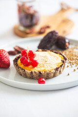 Delectable Mini Tart with Fresh Red Currant Berries on White Plate