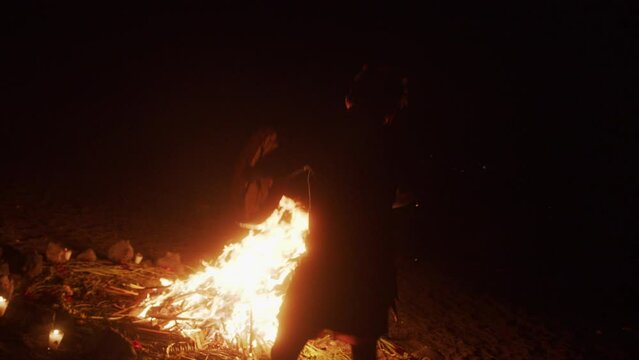 An Indigenous Shaman Dancing around the Bonfire