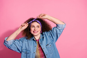 Photo of funky dreamy lady dressed denim outfit adjusting hairband looking emtpy space isolated...