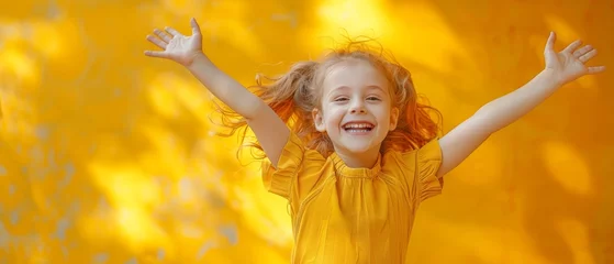 Fotobehang Yellow colored background with a funny young girl jumping on it © Zaleman