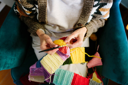 Top view of woman&rsquo;s hands crocheting