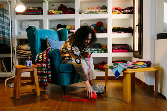 Woman knits in her workroom