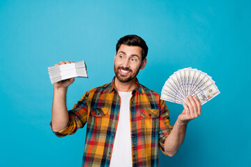 Portrait of toothy beaming guy with stubble wear checkered shirt hold money get profit from...
