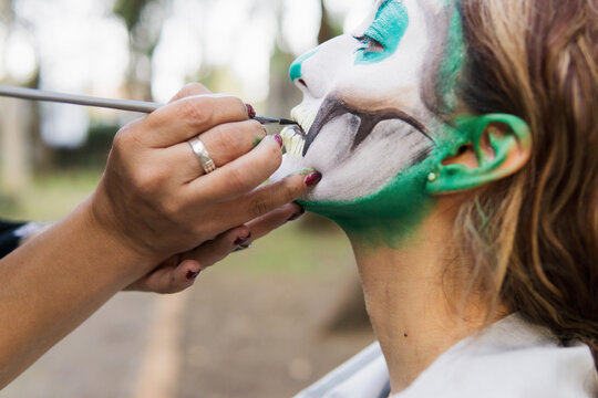 Close-up of a makeup artist using a makeup brush.
