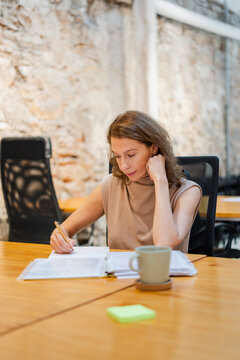 Middle-Aged Woman In Modern Workplace