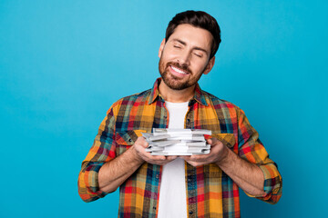 Portrait of satisfied guy with stubble wear checkered shirt holding dollars in hands receive salary...