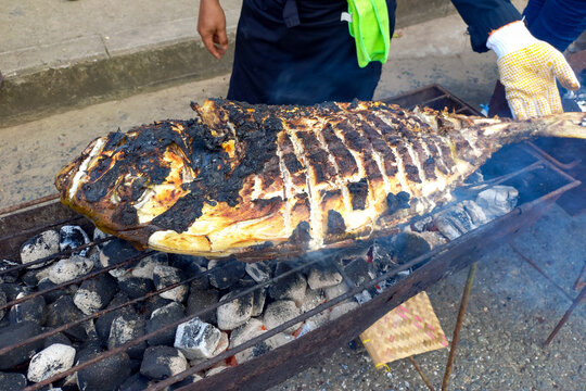 Grilling a giant fish in open air restaurant.