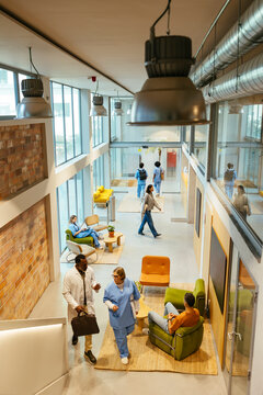 Medical workers and patients in hospital hall