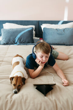 Boy watching cartoons on tablet.