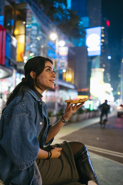Smiling woman in Times Square at night