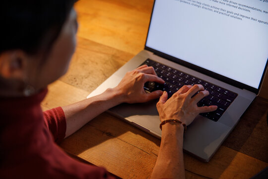 Closeup of woman working on laptop at home