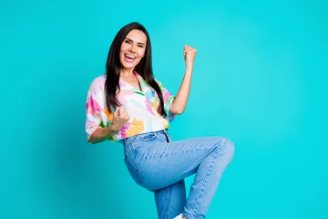 Fotobehang Photo of nice lady raise fists accomplish empty space wear shirt isolated on turquoise color background © deagreez