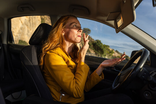 woman putting cream inside the car