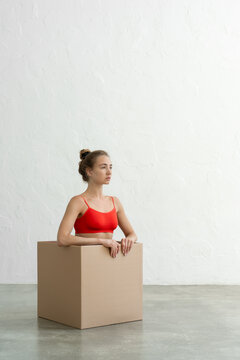Performance of athletic woman in bright red tights with craft bo