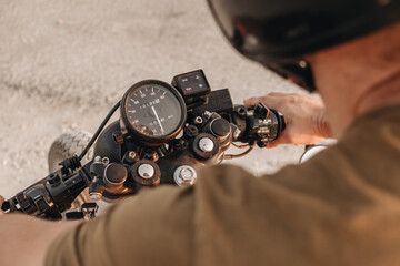 A man holding the handlebars of the motorcycle