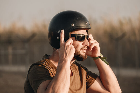 Biker Adjusting Helmet