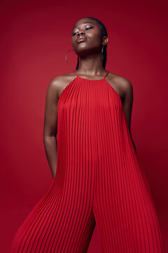 Fashionable black model posing on red background