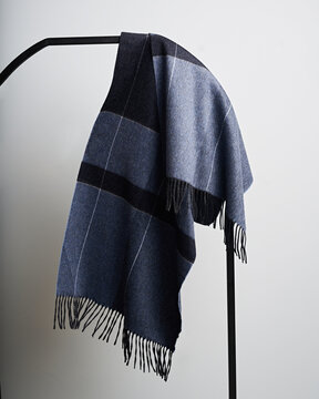 Stylish men's scarf hanging on hanger