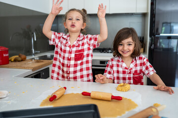 Sibling making Christmas cookies