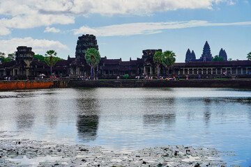 Angkor Wat Temple skyline against a bright blue sky with clouds at mid day at Siem Reap, Cambodia,...