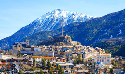 Panoramic view of the skyline of the walled city of Briançon built by Vauban on top of a rocky spur in a mountainous valley of the French Alps