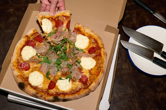 Serving pizza