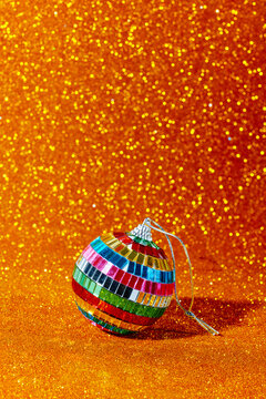 mirror christmas ball on a golden glittering background
