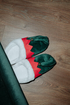 elf shoes on the floor under the armchair
