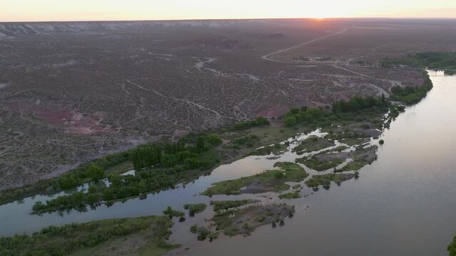 Aerial shot of the overgrowth river causing flooding as a result of global warming. Valle de Rio Negro Valley, Argentina