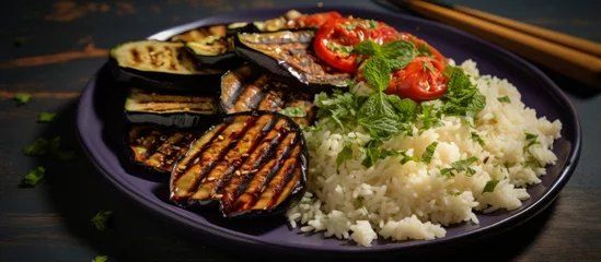Tuinposter A delicious dish of rice and vegetables served on a table, showcasing a mix of staple food ingredients. Perfect for sharing and enjoyed as a healthy cuisine option © AkuAku
