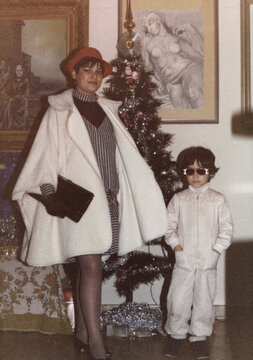 1983. Mother and son posing in front of the Christmas tree.