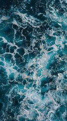Fototapeta premium Captivating overhead shot of chaotic, foamy ocean waves in numerous shades of blue