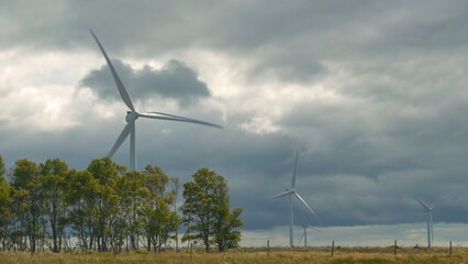 Operating wind powered structures located in remote part of Scottish countryside - obrazy, fototapety, plakaty