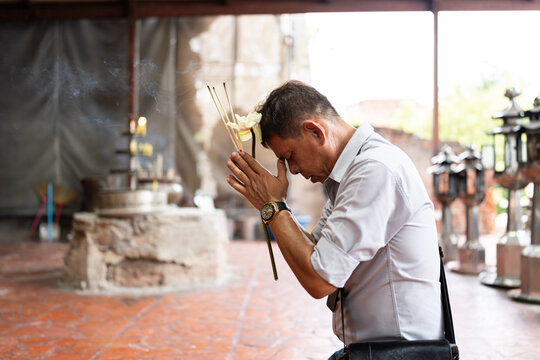 Man praying at temple.