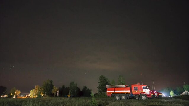 Timelapse with fire truck and starry sky in the forest