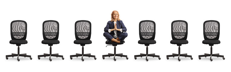 Businesswoman sitting on a chair and meditating