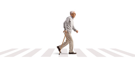 Full length profile shot of a mature gentleman walking with a cane at a pedestrian crossing