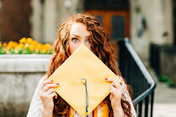 Young woman with yellow Graduate cap