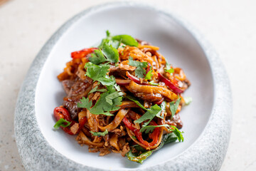 Asian dish with noodles, meat and herbs