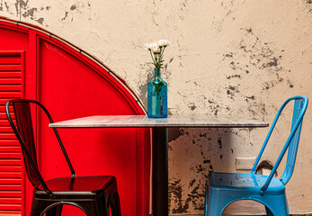 Black and Blue chairs against red plaster wall