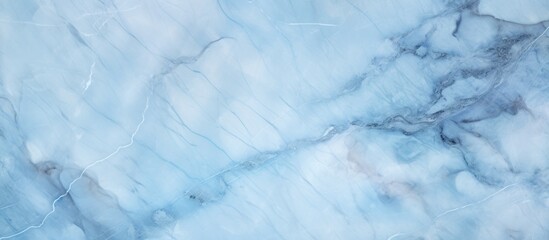 A closeup shot of a light blue marble texture resembling a cumulus cloud in the sky. The pattern mimics a natural landscape with an electric blue hue, reminiscent of a freezing winter day