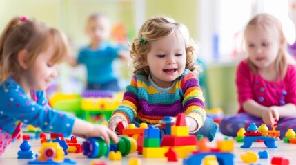 Happy toddlers playing with colorful building blocks in a bright playroom setting.