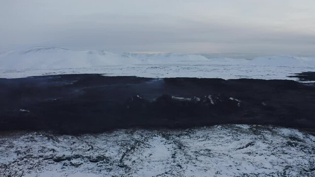 Aerial video on hot earth - lava in Iceland in a snowy winter