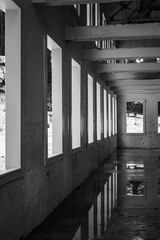 Windows receding into distance in old concrete mining building in winter