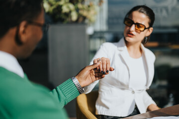 Multicultural business partners discussing strategies for marketing, sales, and business growth at a sunny outdoor meeting.