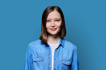 Young smiling attractive woman on blue background