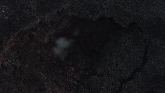 Aerial video on hot earth - lava in Iceland in a snowy winter