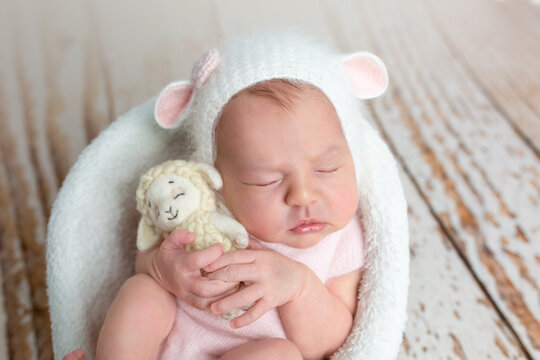 newborn girl in a sheep's hat. first photo session of a newborn baby