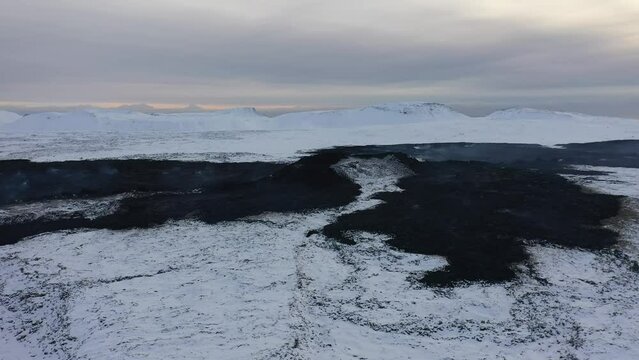 Aerial video on hot earth - lava in Iceland in a snowy winter
